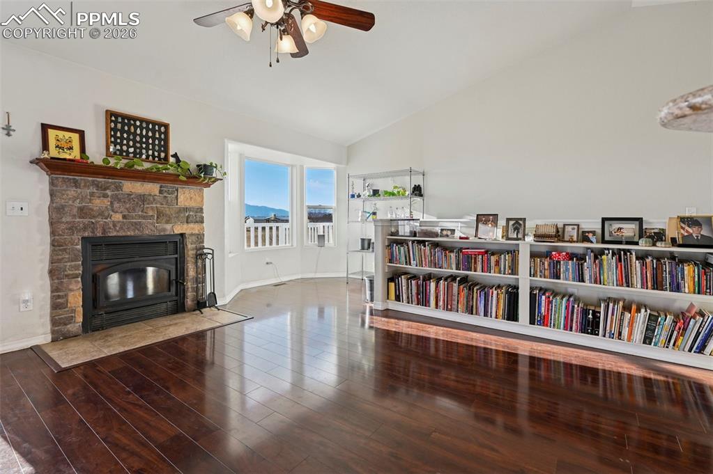 16575 Cathys Loop Peyton, CO 80831 - Photo 9 of 49 a living room with lots of furniture and a fireplace