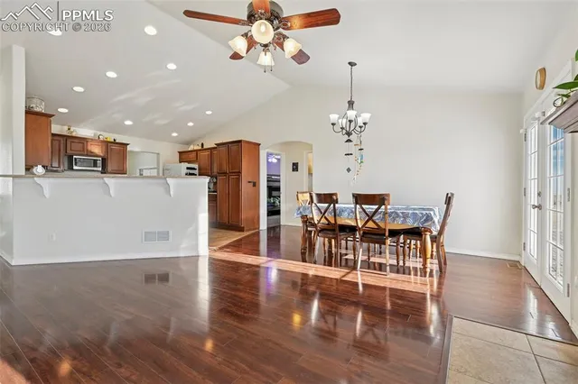 a view of a dining room with furniture and wooden floor