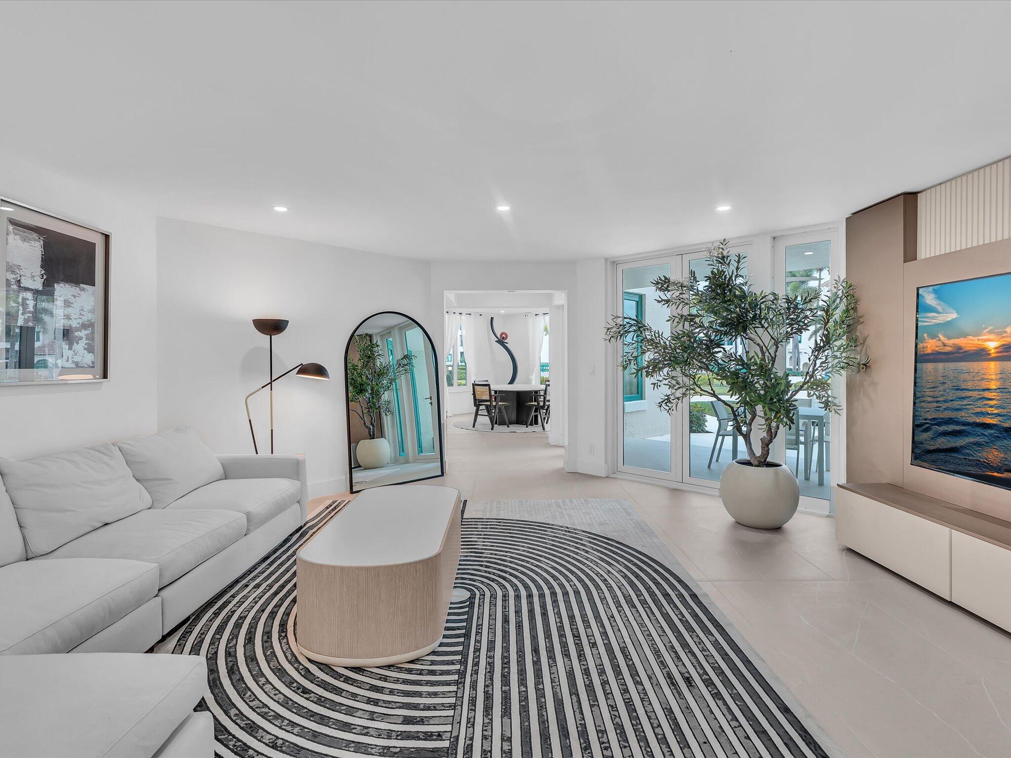 a living room with furniture and potted plant