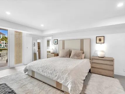 a bedroom with a bed and a night stand