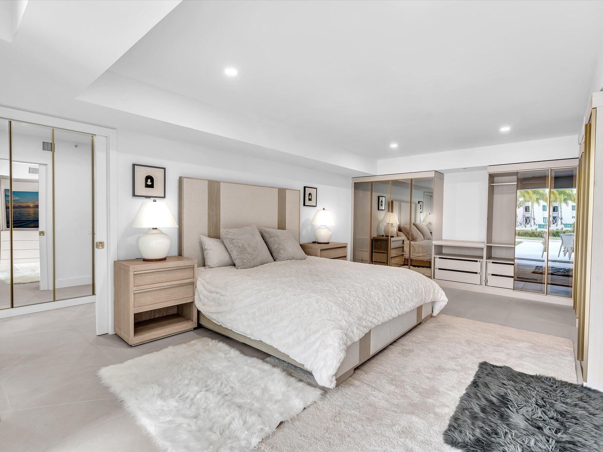 120 Southeast 5th Avenue, Unit 225 Boca Raton, FL 33432 - Photo 12 of 42 a spacious bedroom with a bed and window
