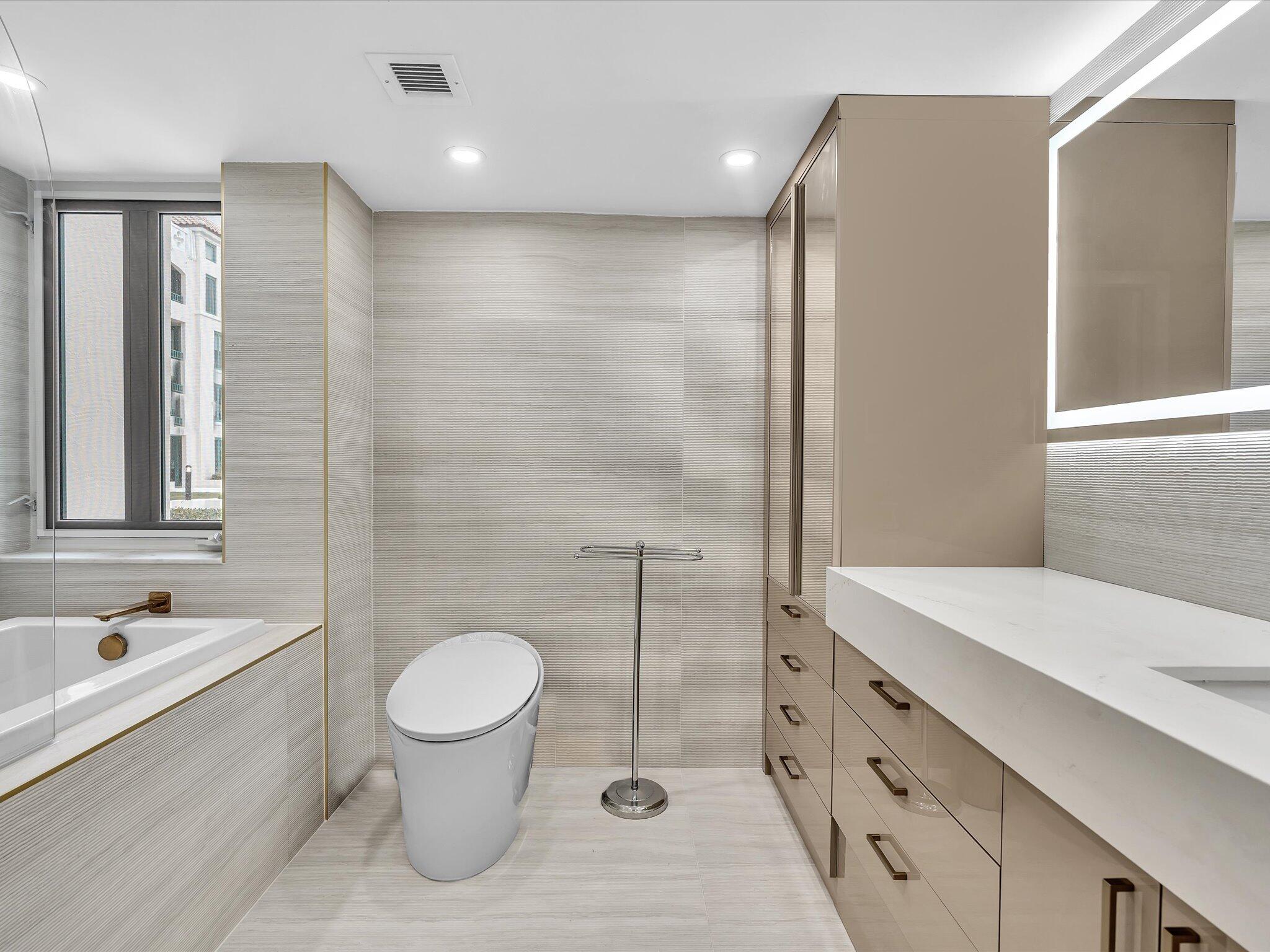 120 Southeast 5th Avenue, Unit 225 Boca Raton, FL 33432 - Photo 14 of 42 a bathroom with a sink a toilet and shower