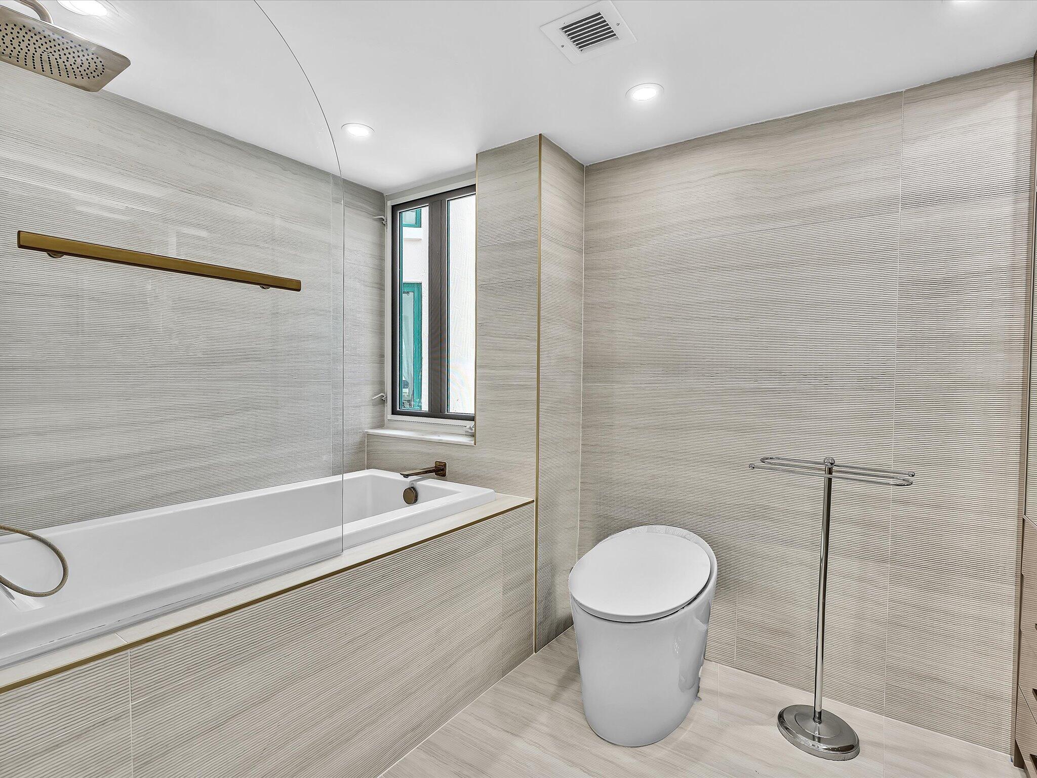 120 Southeast 5th Avenue, Unit 225 Boca Raton, FL 33432 - Photo 15 of 42 a bathroom with a toilet a sink and bathtub