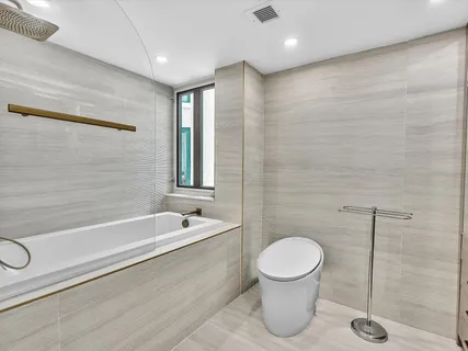 a bathroom with a toilet a sink and bathtub