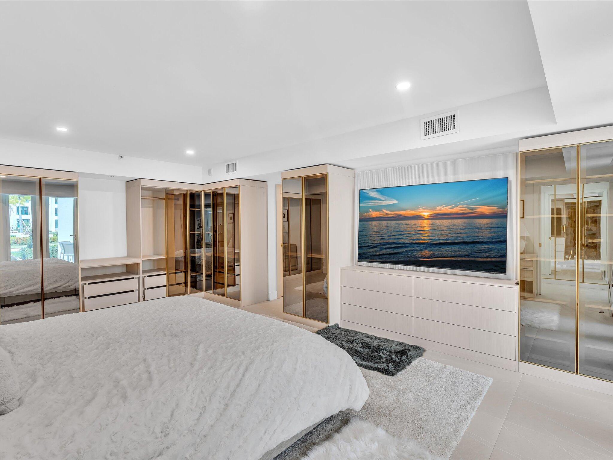 120 Southeast 5th Avenue, Unit 225 Boca Raton, FL 33432 - Photo 17 of 42 a bedroom with a bed and a flat screen tv