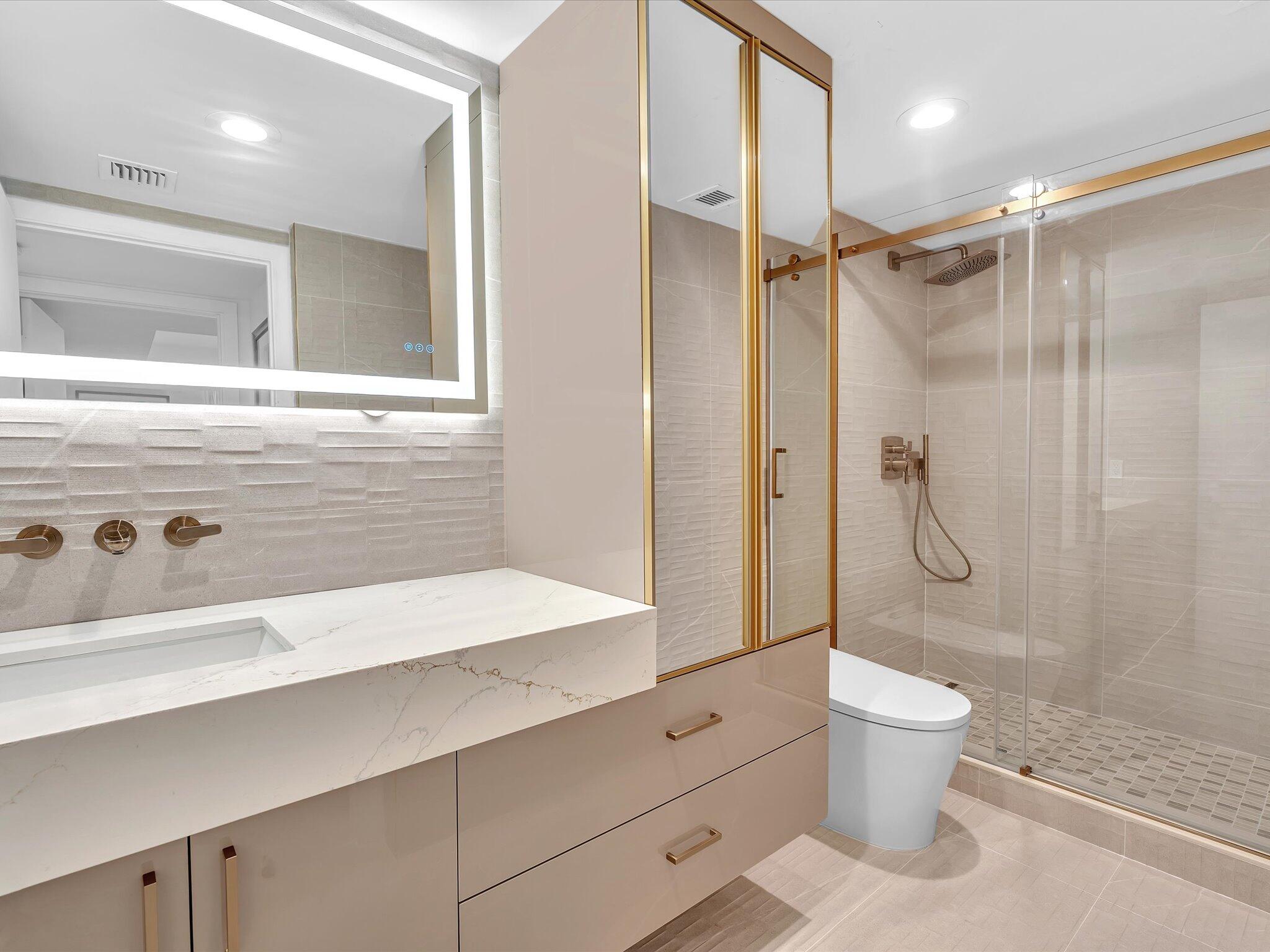 120 Southeast 5th Avenue, Unit 225 Boca Raton, FL 33432 - Photo 21 of 42 a bathroom with a shower sink vanity mirror and toilet