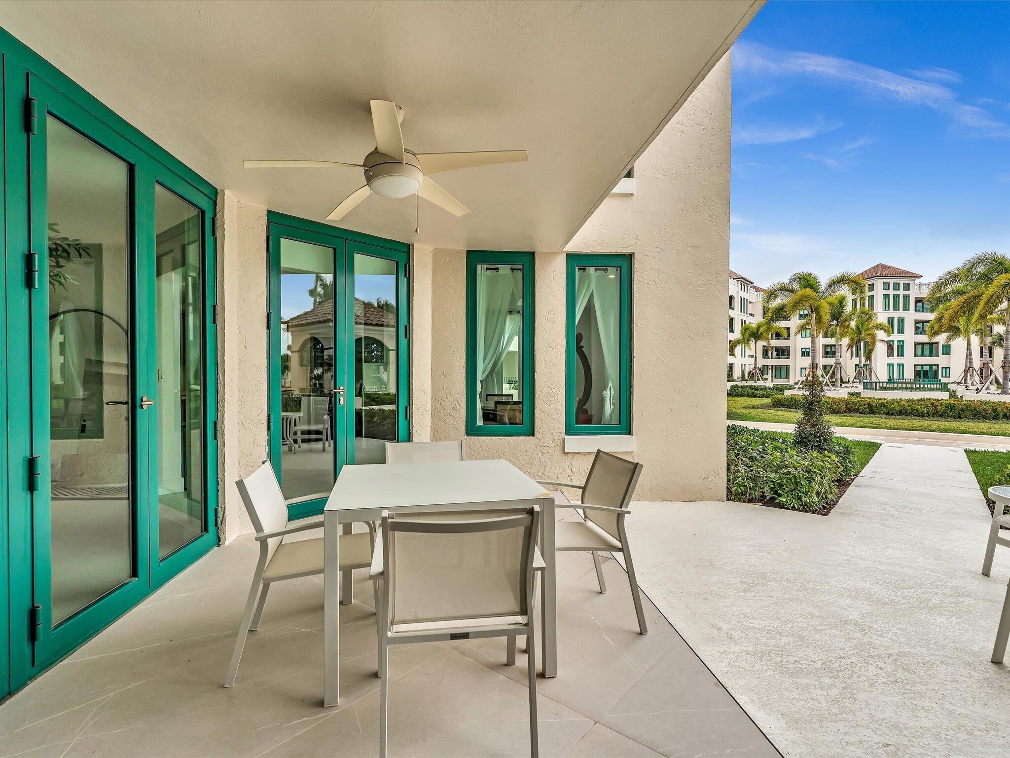 120 Southeast 5th Avenue, Unit 225 Boca Raton, FL 33432 - Photo 26 of 42 a patio with a table and chairs and potted plants