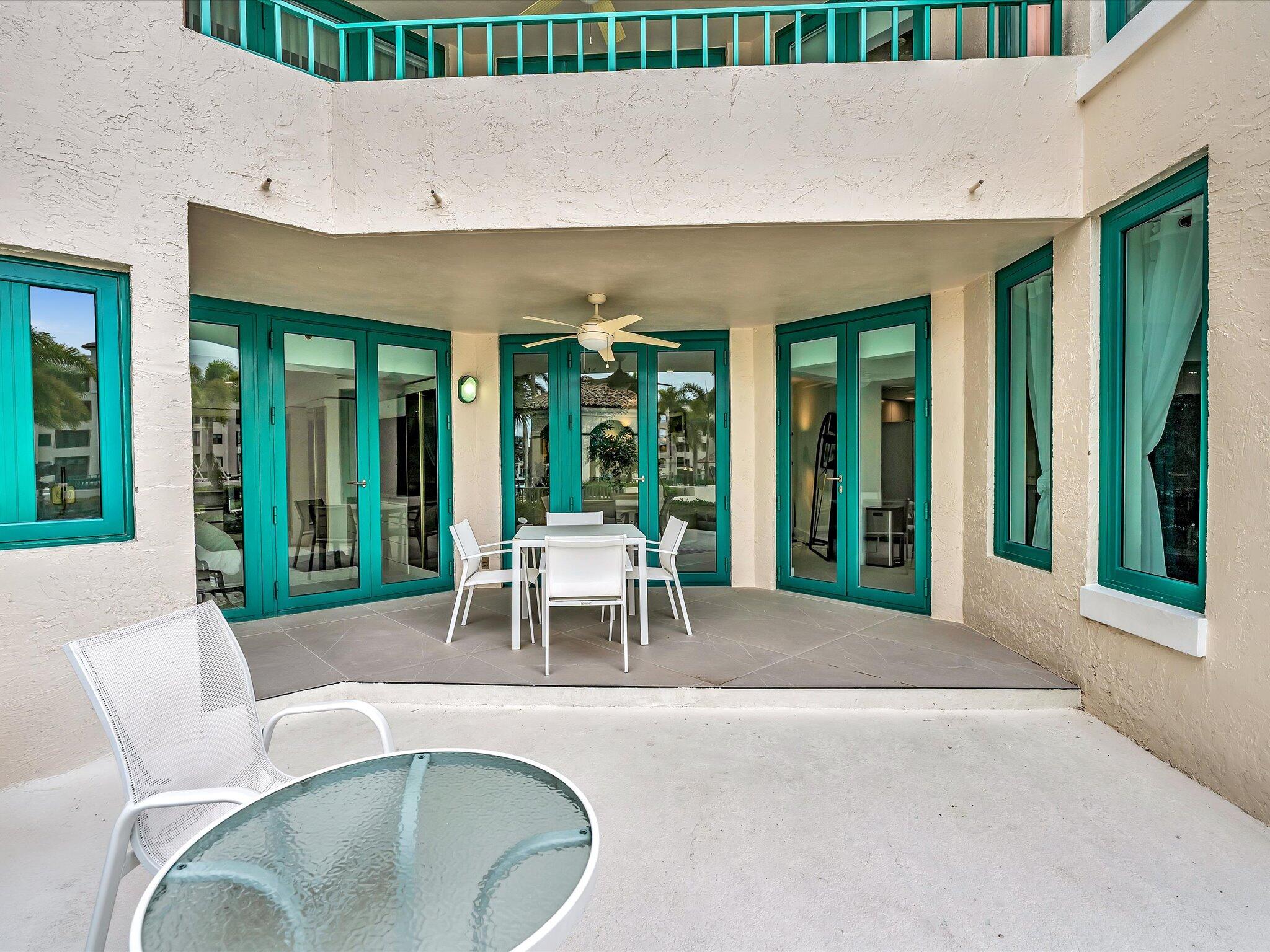 120 Southeast 5th Avenue, Unit 225 Boca Raton, FL 33432 - Photo 28 of 42 a view of a patio with couches table and chairs and potted plants