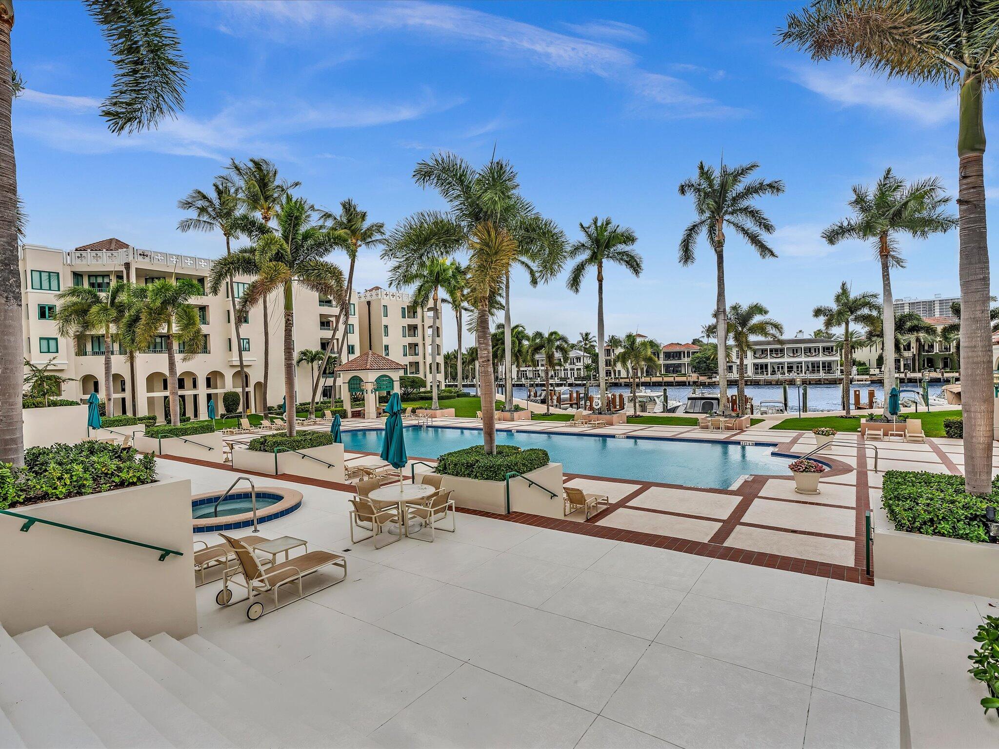 120 Southeast 5th Avenue, Unit 225 Boca Raton, FL 33432 - Photo 30 of 42 a row of palm trees and swimming pool in the backyard of a house