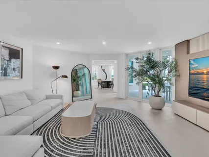 a living room with furniture and potted plant