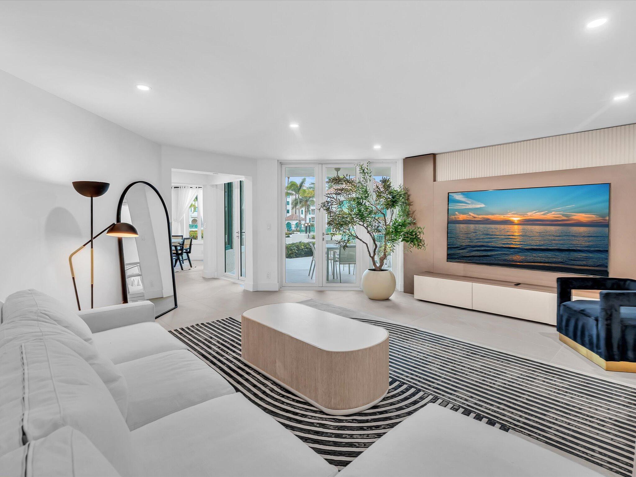 120 Southeast 5th Avenue, Unit 225 Boca Raton, FL 33432 - Photo 3 of 42 a living room with furniture and a flat screen tv