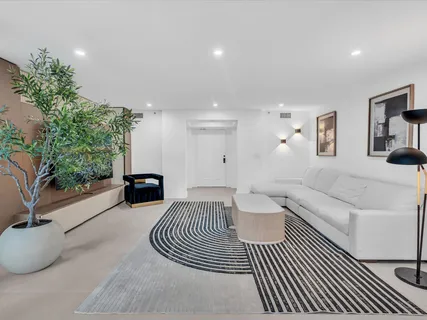 a spacious bedroom with a bed and a couch