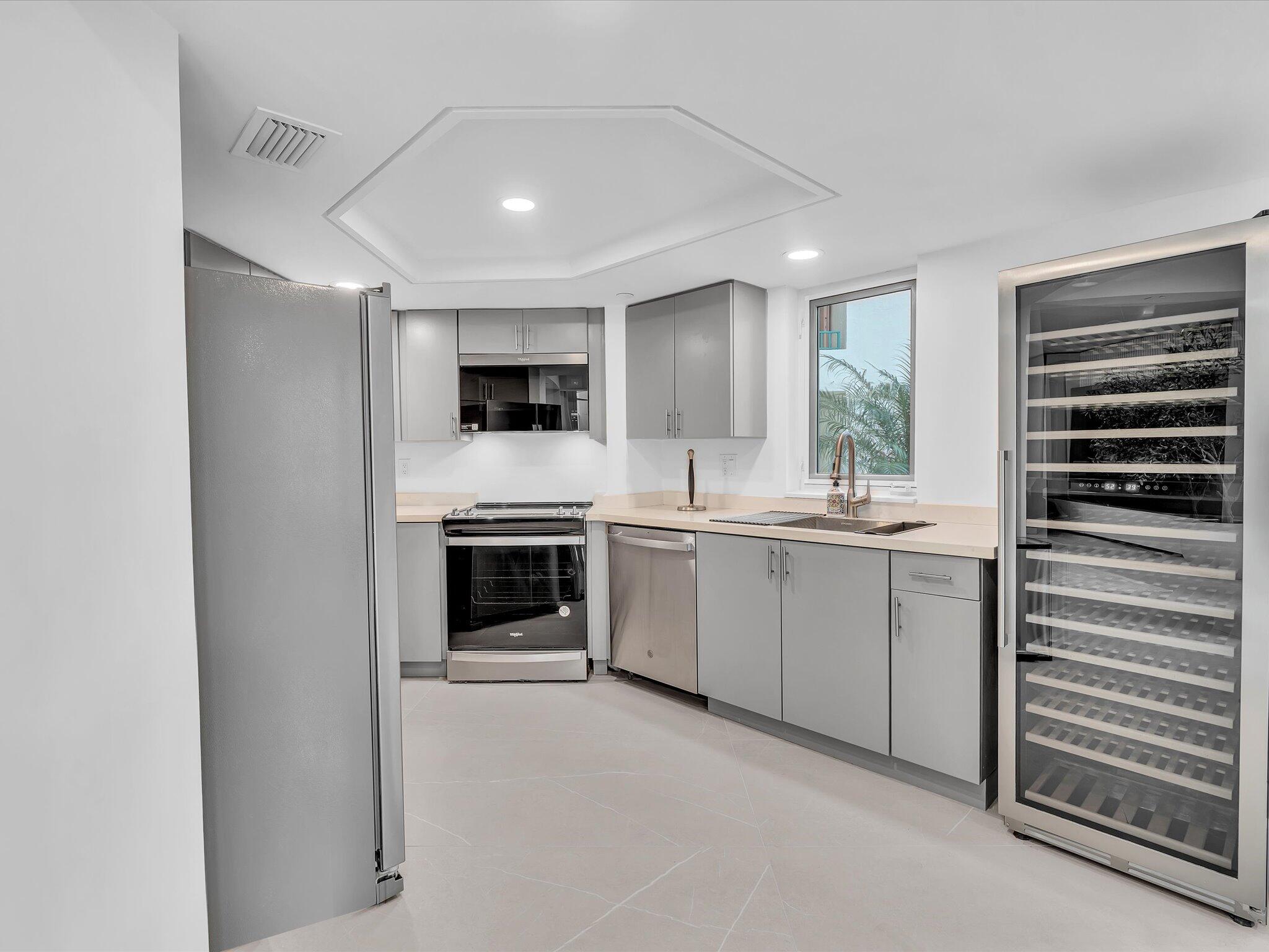 120 Southeast 5th Avenue, Unit 225 Boca Raton, FL 33432 - Photo 6 of 42 a kitchen with a refrigerator stove and microwave