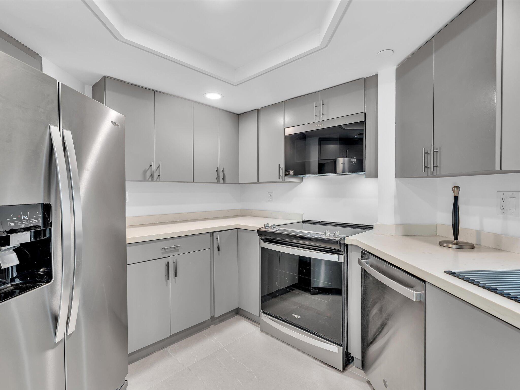 120 Southeast 5th Avenue, Unit 225 Boca Raton, FL 33432 - Photo 7 of 42 a kitchen with stainless steel appliances granite countertop a refrigerator stove and sink