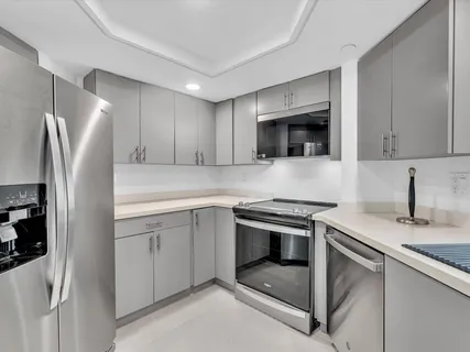 a kitchen with stainless steel appliances granite countertop a refrigerator stove and sink