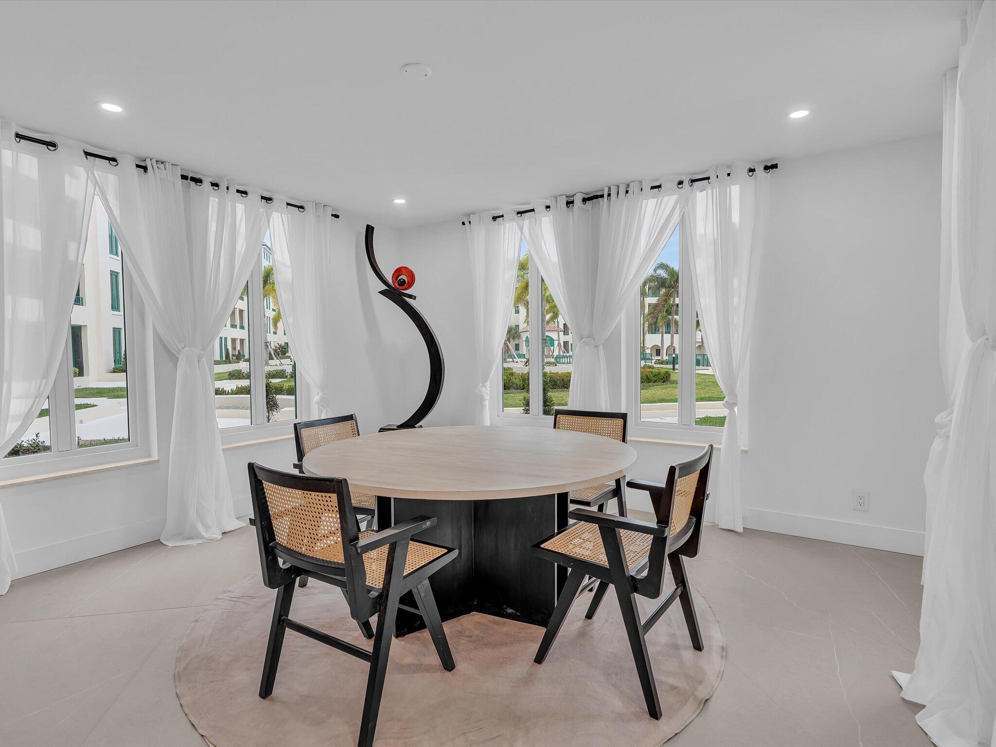 120 Southeast 5th Avenue, Unit 225 Boca Raton, FL 33432 - Photo 9 of 42 a view of a dining room with furniture and a window