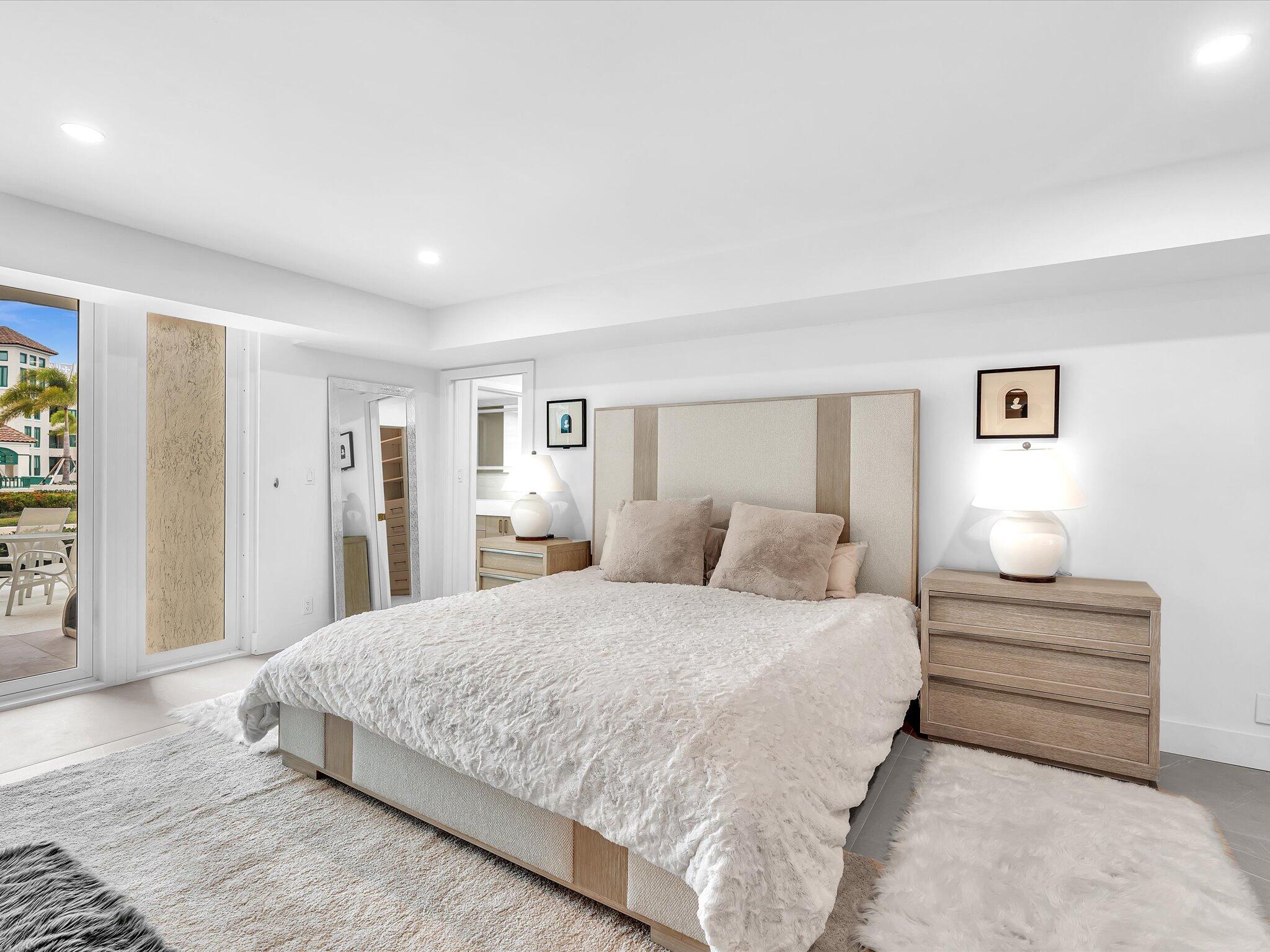 120 Southeast 5th Avenue, Unit 225 Boca Raton, FL 33432 - Photo 10 of 42 a bedroom with a bed and a night stand