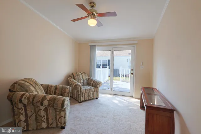 a living room with couches and a chandelier
