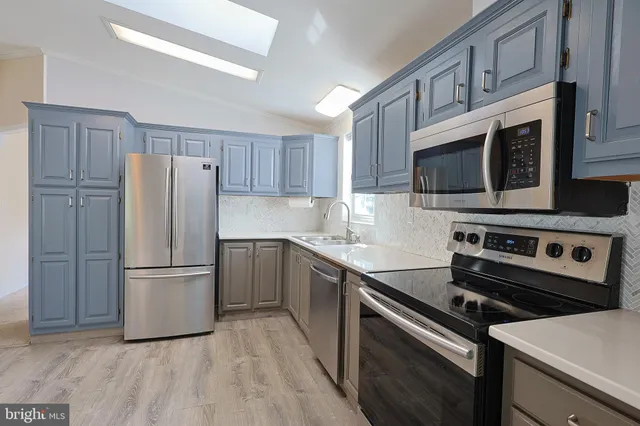 a kitchen with a refrigerator stove and microwave