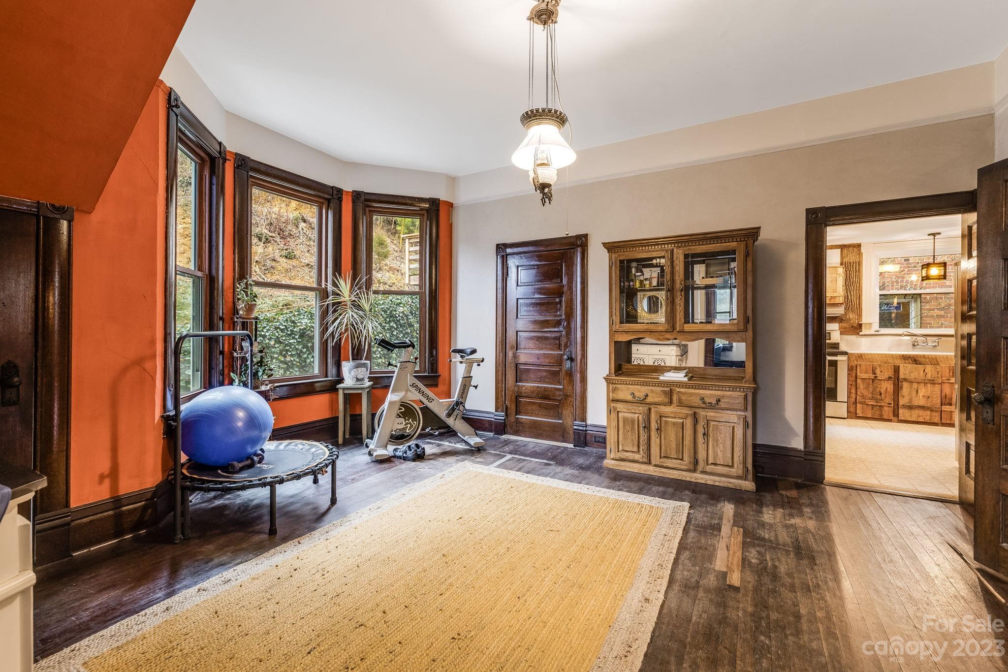 2412 Stackhouse Road Marshall, NC 28753 - Photo 15 of 48 a room with wooden floor and furniture