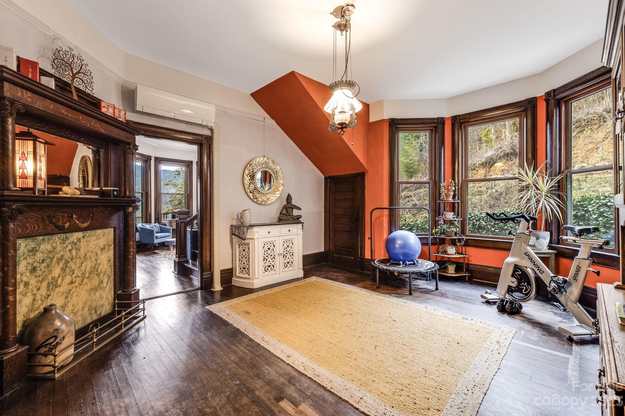 2412 Stackhouse Road Marshall, NC 28753 - Photo 16 of 48 a living room with furniture a fireplace and a large window