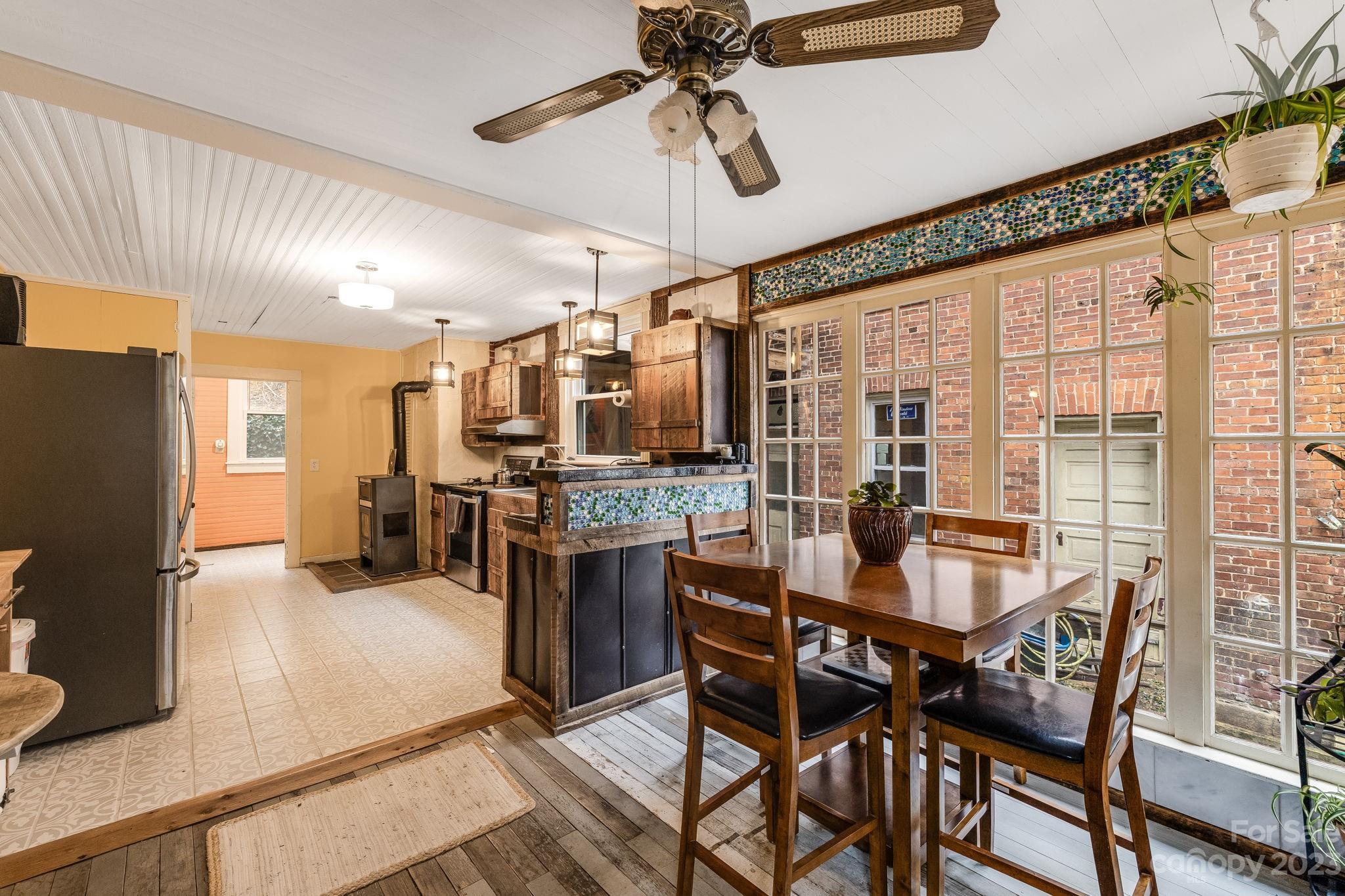 2412 Stackhouse Road Marshall, NC 28753 - Photo 17 of 48 a view of a dining room with furniture window and wooden floor