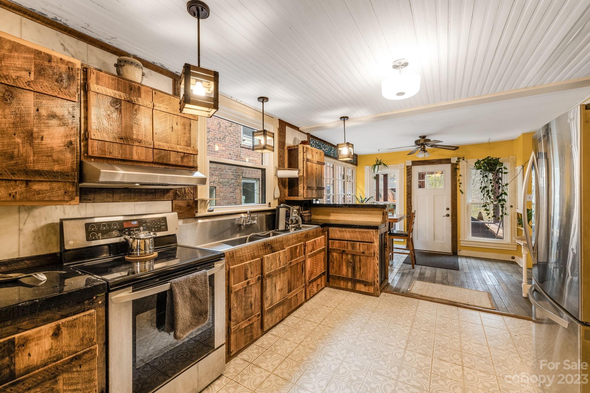 2412 Stackhouse Road Marshall, NC 28753 - Photo 18 of 48 a kitchen with stainless steel appliances granite countertop a stove and a refrigerator