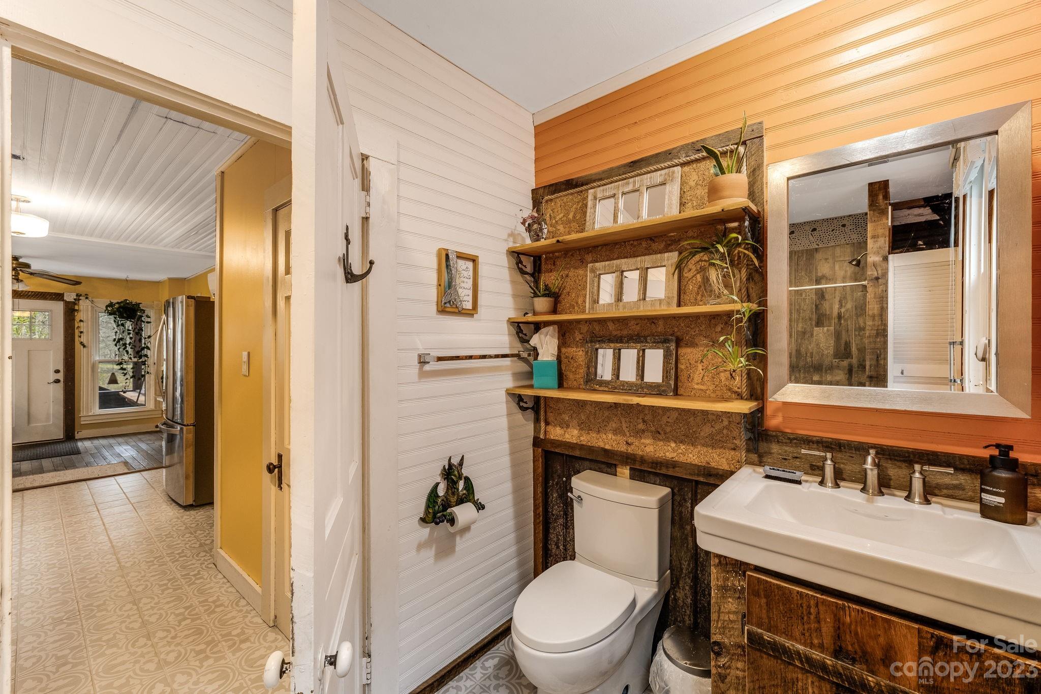 2412 Stackhouse Road Marshall, NC 28753 - Photo 20 of 48 a bathroom with a toilet a sink and a window