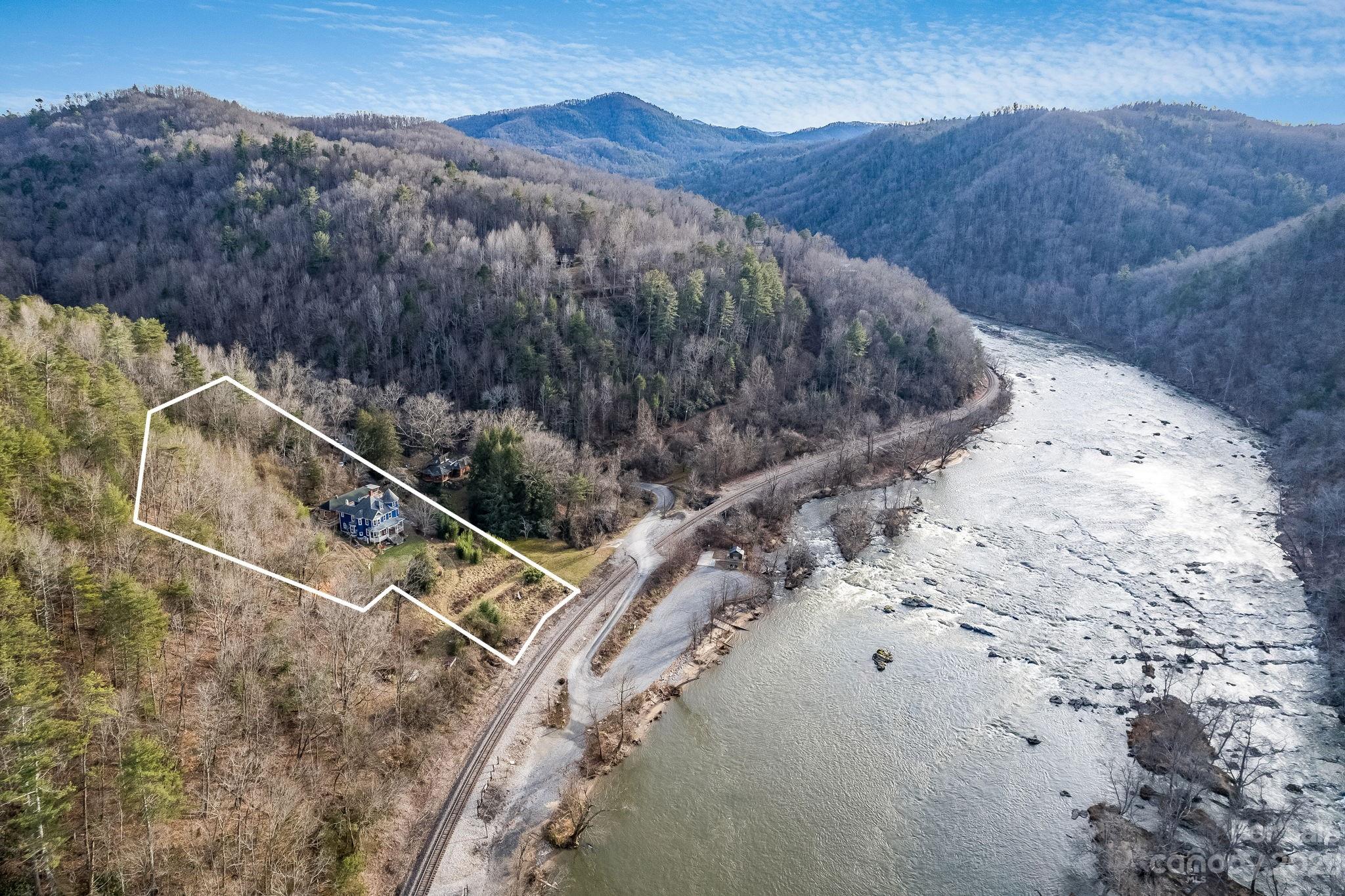 2412 Stackhouse Road Marshall, NC 28753 - Photo 2 of 48 a view of a backyard with a mountain
