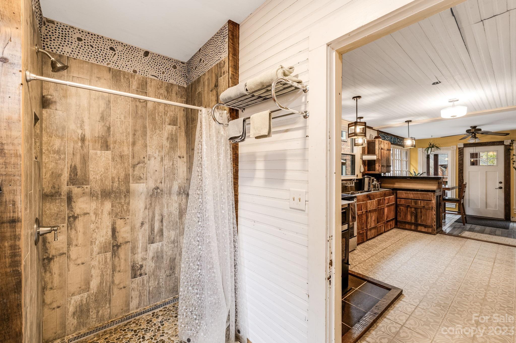 2412 Stackhouse Road Marshall, NC 28753 - Photo 21 of 48 a bathroom with a shower and a sink