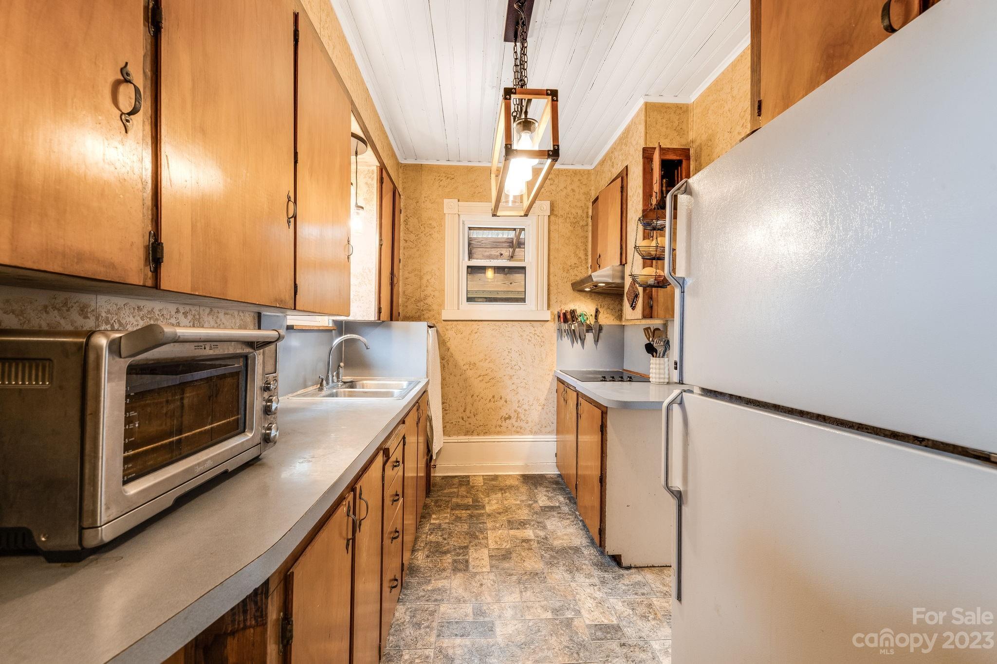 2412 Stackhouse Road Marshall, NC 28753 - Photo 26 of 48 a kitchen with stainless steel appliances granite countertop a sink a stove and a refrigerator