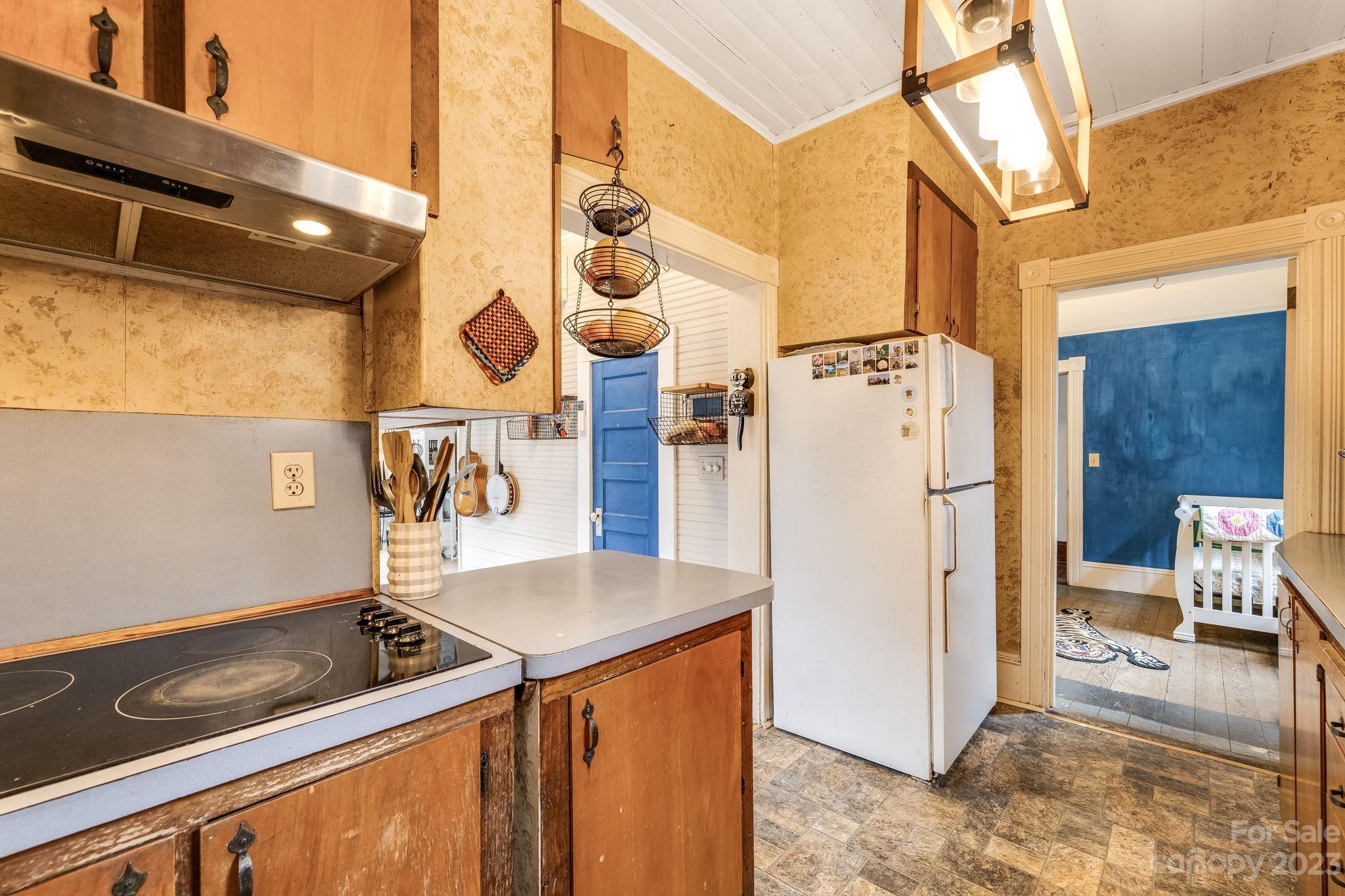 2412 Stackhouse Road Marshall, NC 28753 - Photo 27 of 48 a kitchen with stainless steel appliances granite countertop a sink and a refrigerator