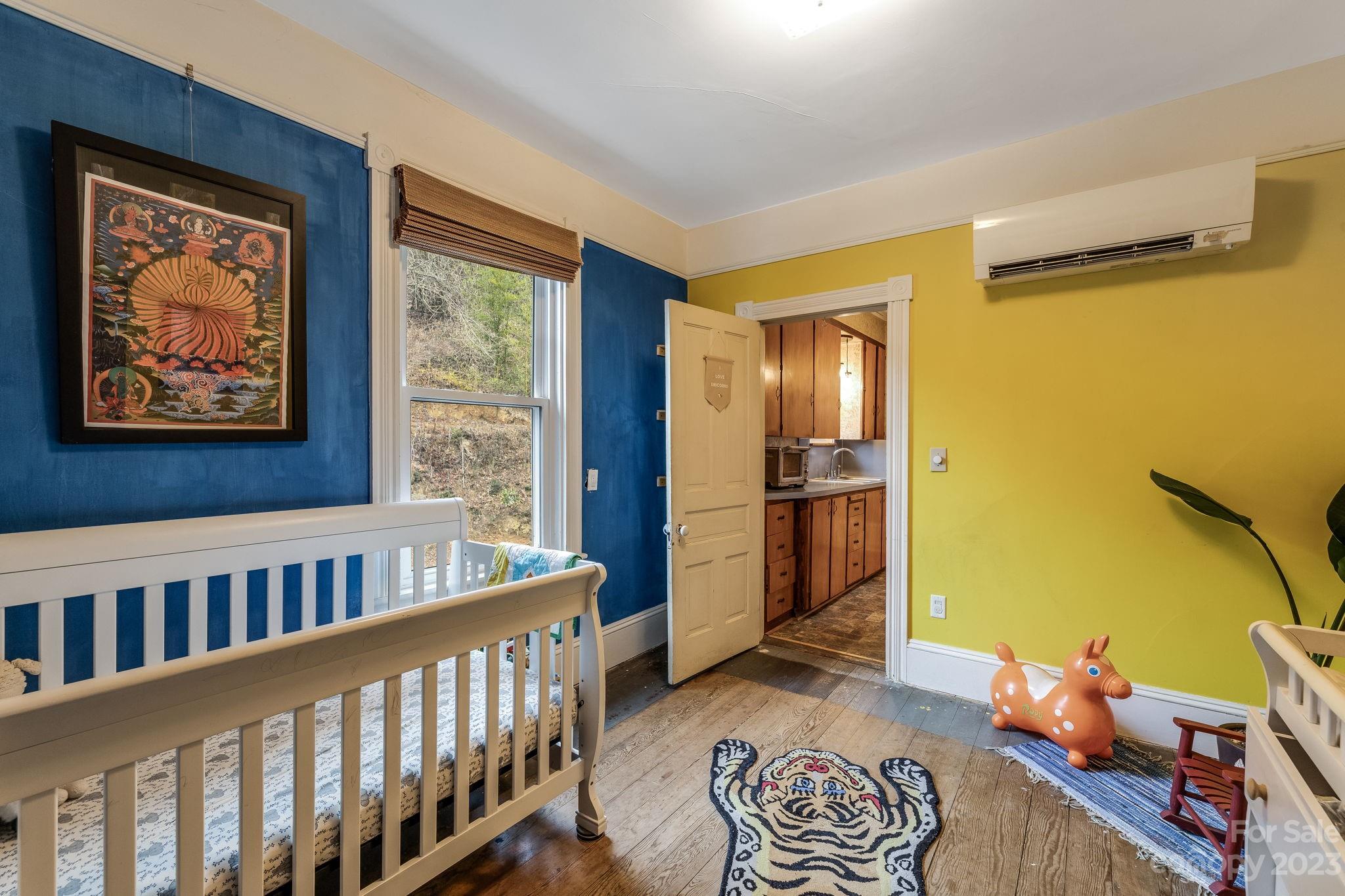 2412 Stackhouse Road Marshall, NC 28753 - Photo 30 of 48 a bedroom with furniture and wooden floor