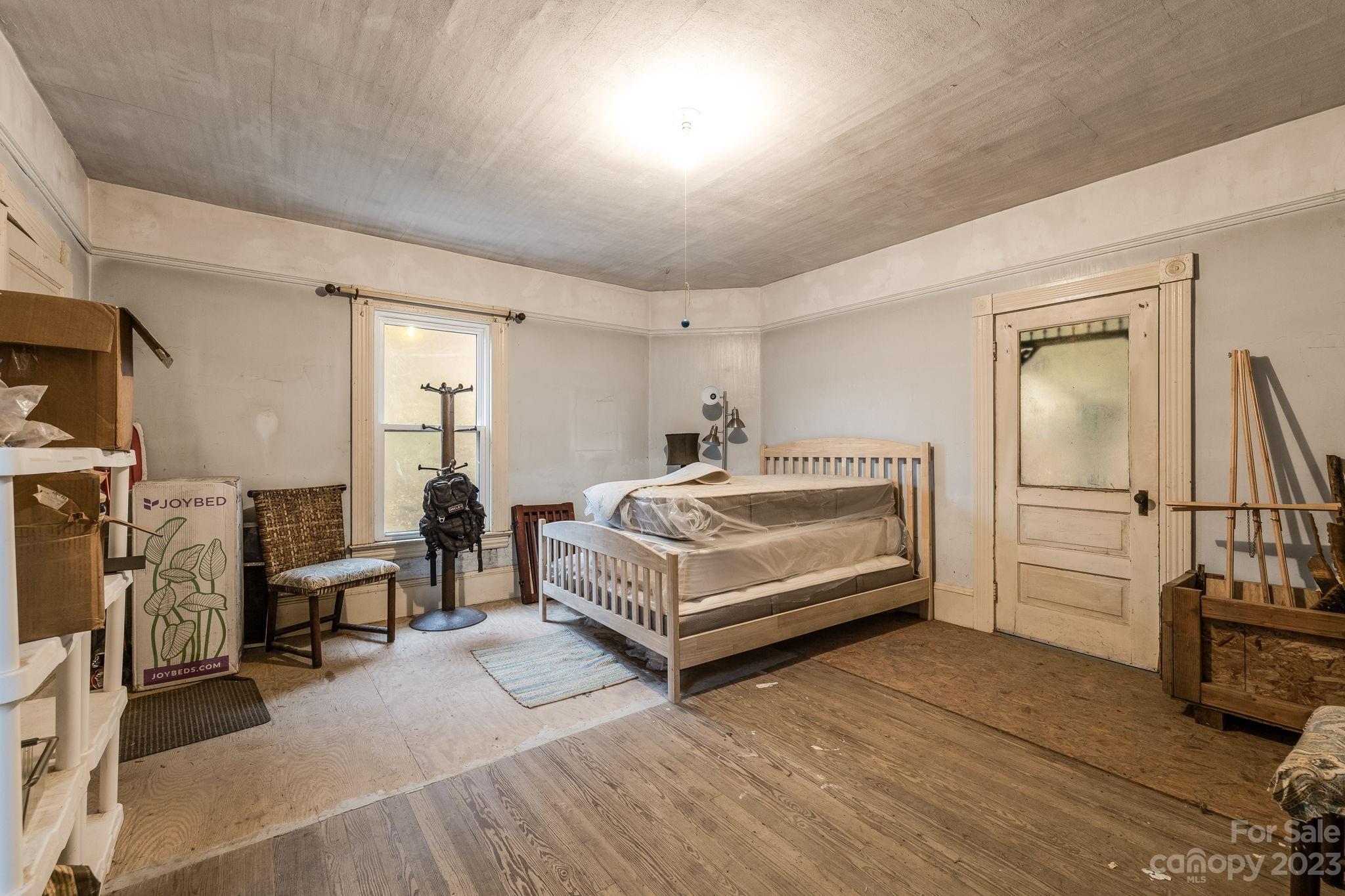 2412 Stackhouse Road Marshall, NC 28753 - Photo 42 of 48 a bedroom with furniture and a flat screen tv