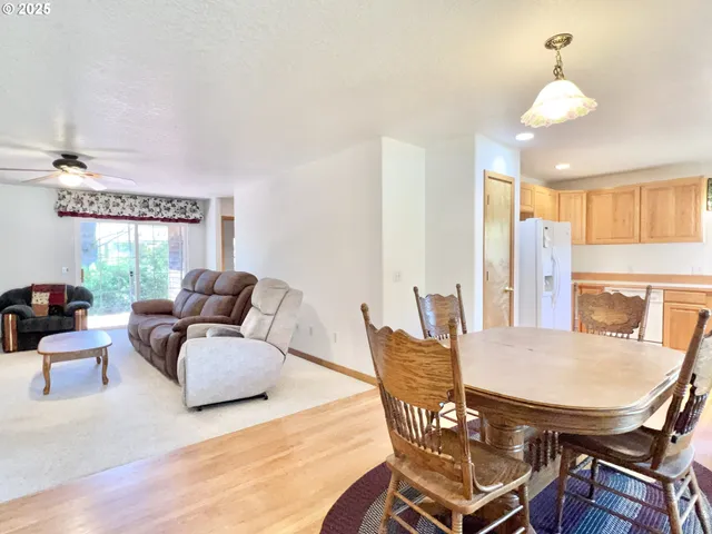 a living room with furniture a fireplace and a chandelier