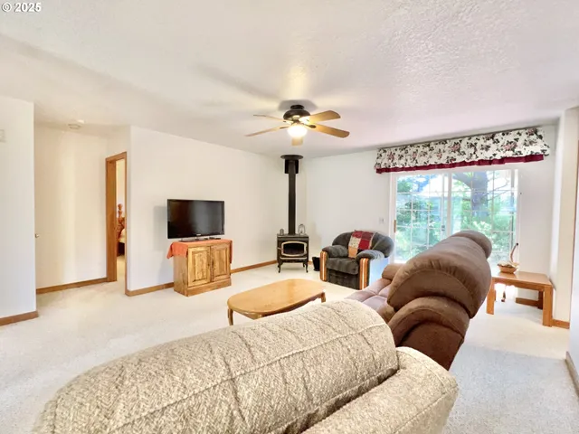 a bedroom with furniture and a large window