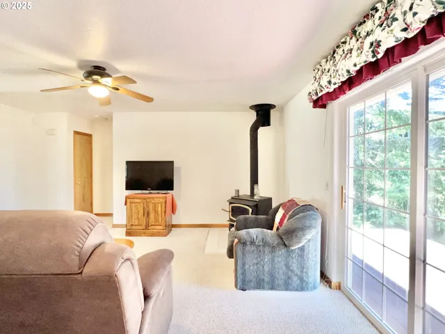 a living room with furniture chandelier and a large window