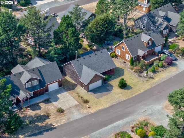 an aerial view of a house with garden space and street view