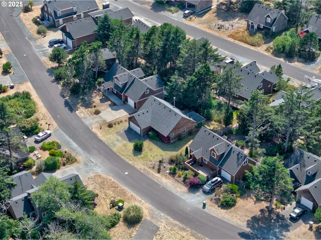 an aerial view of a house with a garden and trees