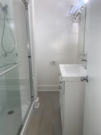 a bathroom with a granite countertop shower