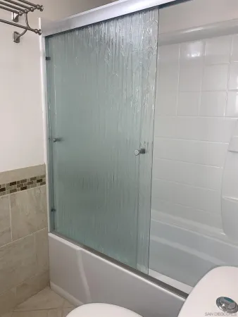 a bathroom with a shower and a toilet