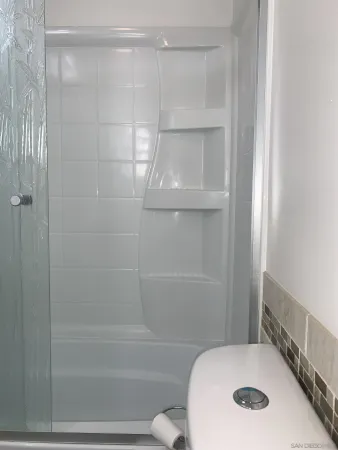 a bathroom with a tub and a shower