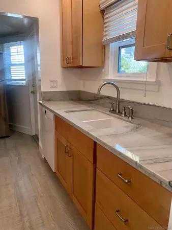 a kitchen with sink and cabinets