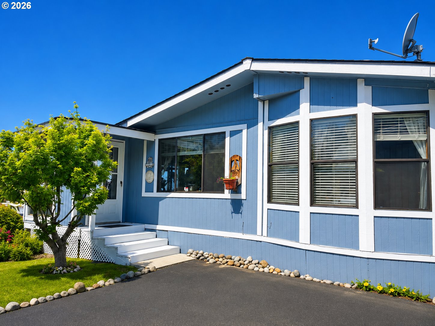 16219 Lower Harbor Road, Unit 16 Brookings, OR 97415 - Photo 2 of 40 a front view of a house with a yard