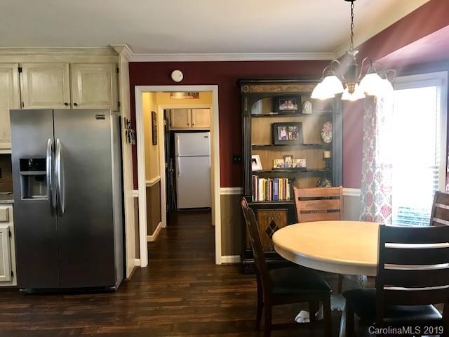 2802 Reece Drive Monroe, NC 28110 - Photo 12 of 37 a kitchen with stainless steel appliances wooden floor dining table and chairs