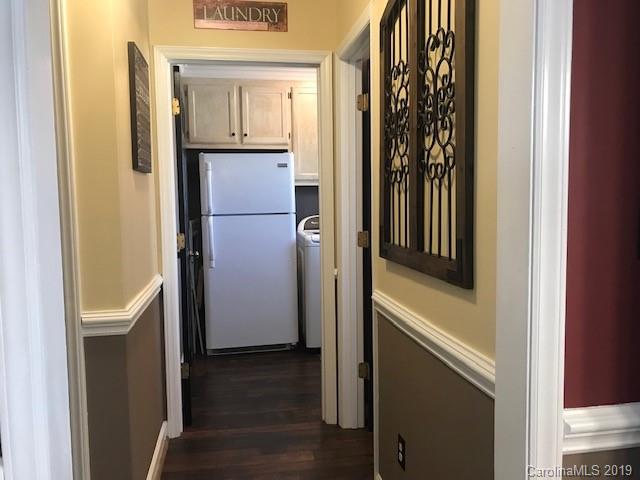 2802 Reece Drive Monroe, NC 28110 - Photo 13 of 37 a view of a hallway with wooden floor and cabinets