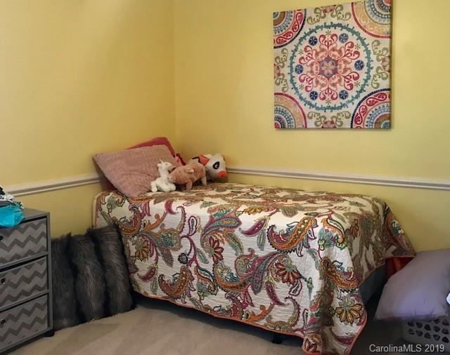 2802 Reece Drive Monroe, NC 28110 - Photo 18 of 37 a bed sitting in a bedroom next to a lamp