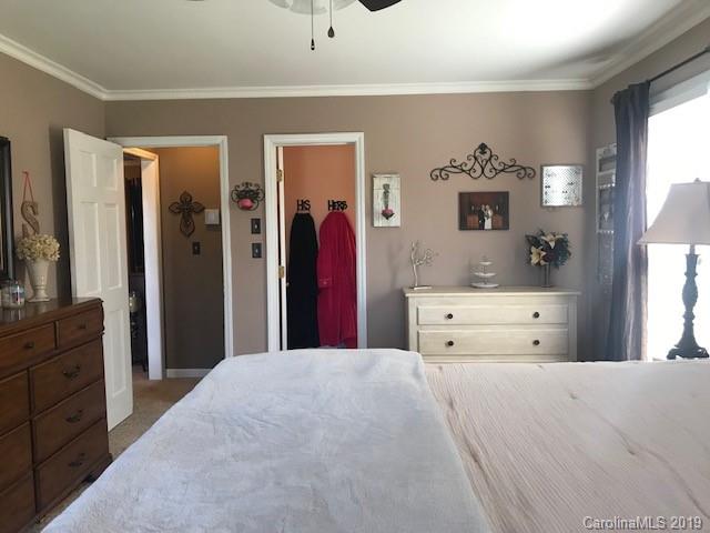 2802 Reece Drive Monroe, NC 28110 - Photo 28 of 37 a large bedroom with a bed and a large mirror