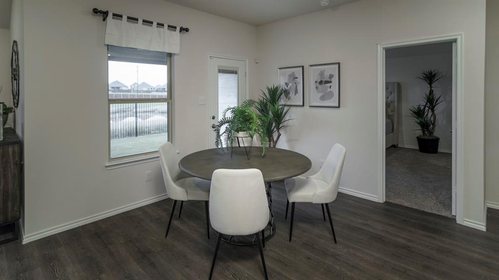 3100 Charleston Drive Ennis, TX 75119 - Photo 22 of 23 Dining area featuring wood-finish flooring and a window with a fenced backyard view
