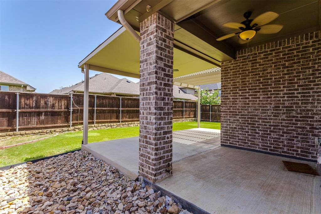 15713 Canyon Ridge Prosper, TX 75078 - Photo 37 of 38 Covered patio featuring brick columns, a ceiling fan with integrated lighting, and concrete flooring